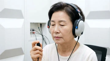 방음부스에서 순음청각검사를 받는 모습